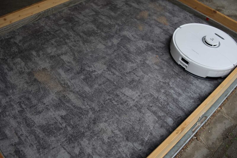 Vacuuming sand on short pile carpet